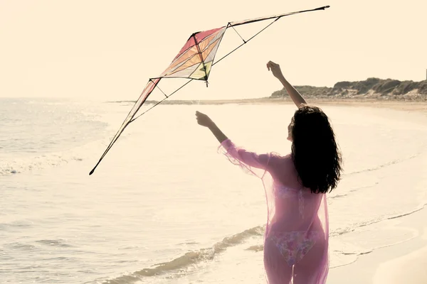 Mediterranean beautiful girl with kite warm filter — Stock Photo, Image