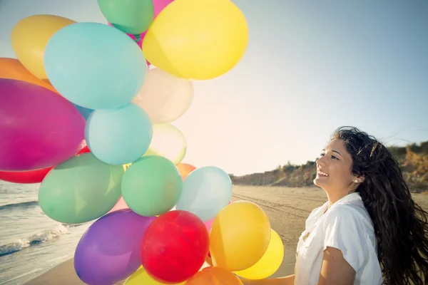 Happy woman with multi colored balloons — Stock Photo, Image