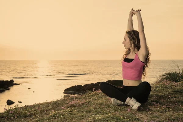 Woman doing fitness exercises warm filter applied — Stock Photo, Image