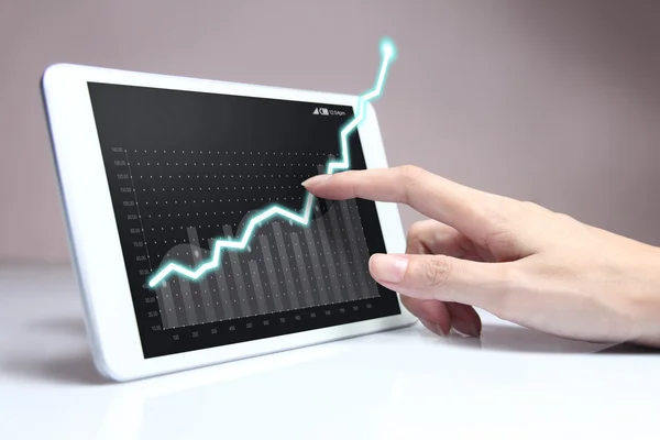 Hand showing a rising graph on tablet — Stock Photo, Image