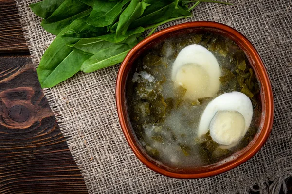 Sorrel soup on dark wooden background. — Stock Image Sorrel soup on dark wooden background. Stock Photo
