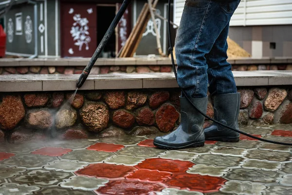 Cleaning paving slab using high pressure power washer. — Stock Photo, Image