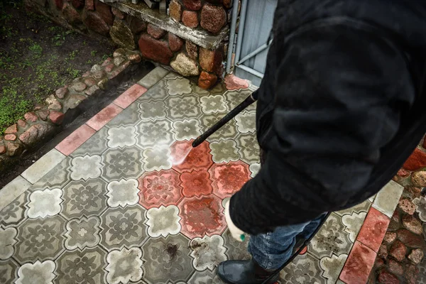 Cleaning paving slab using high pressure power washer. — Stock Photo, Image