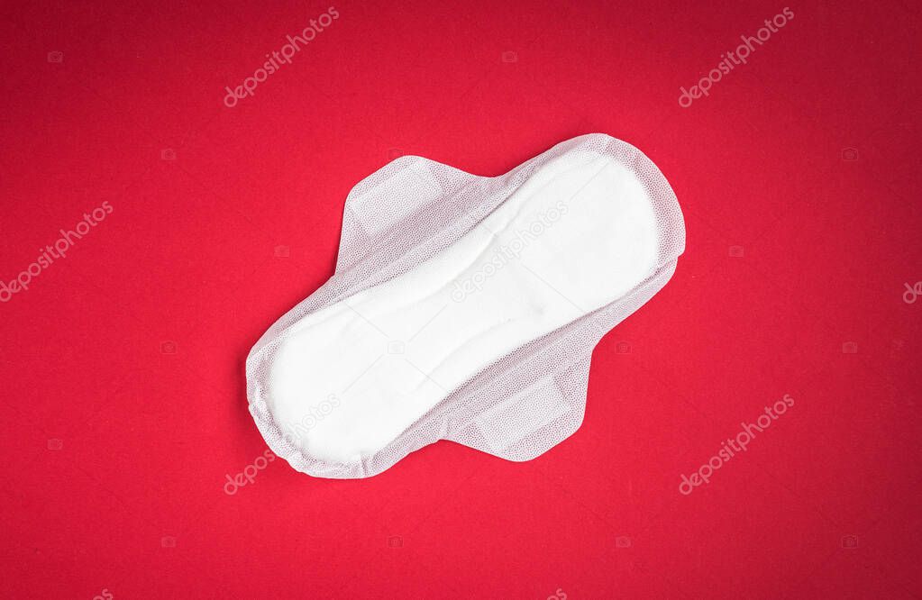 Woman hygiene protection on red. Small and big sanitary pads.