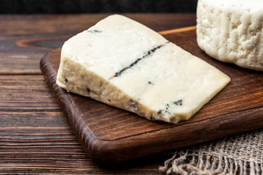 Koyu ahşap arka planda peynir.