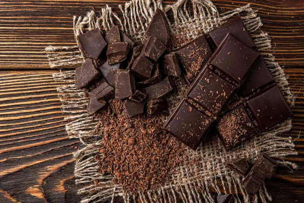 Chocolate bar on dark wooden background.