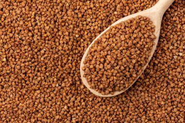 Buckwheat background with wooden spoon.