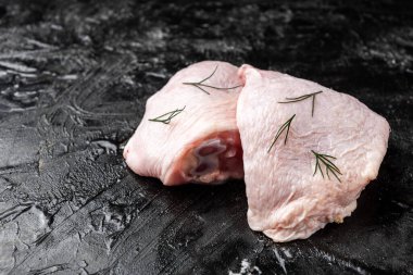 Siyah arka planda çiğ tavuk budu..