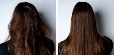 Genç bir kadın saçlarını gri arka planda düzleştiriyor..