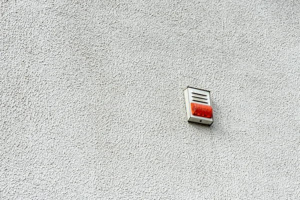 Fire detector on the wall outdoor. White fire alarm.