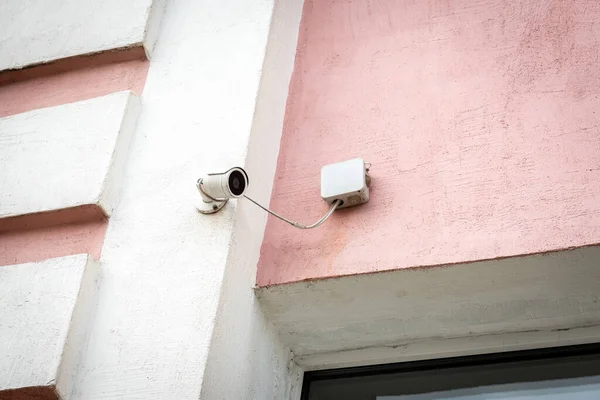 Surveillance camera on the wall of the building outdoor.