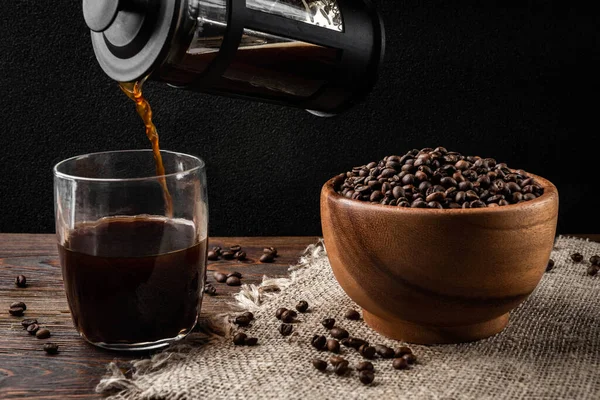 Koyu arkaplandaki fincana Fransız presinden kahve döküyorum..