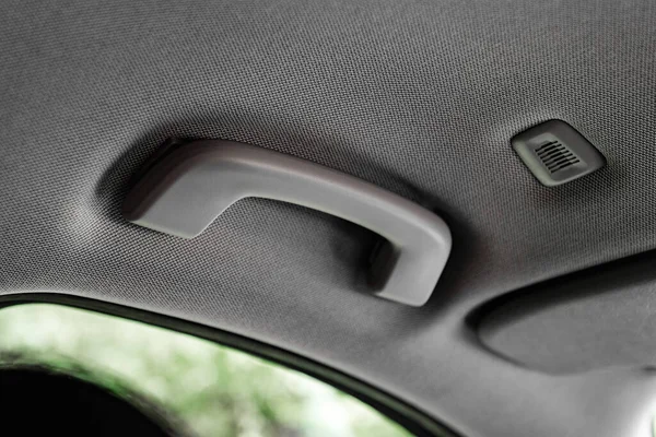 Plastic car grab handle for the passenger in a car.