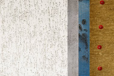 The texture of the multi-layered facade of the building. Mineral wool, facade grid, plaster and decorative plaster.  clipart