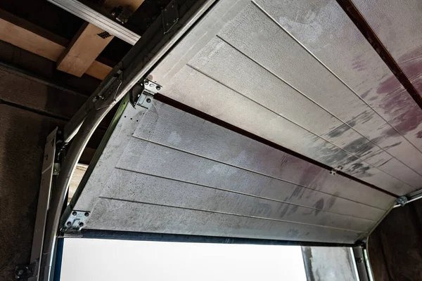 Installation of automatic sectional garage door.