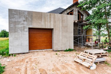 Brown automatic sectional metal garage doors of house.