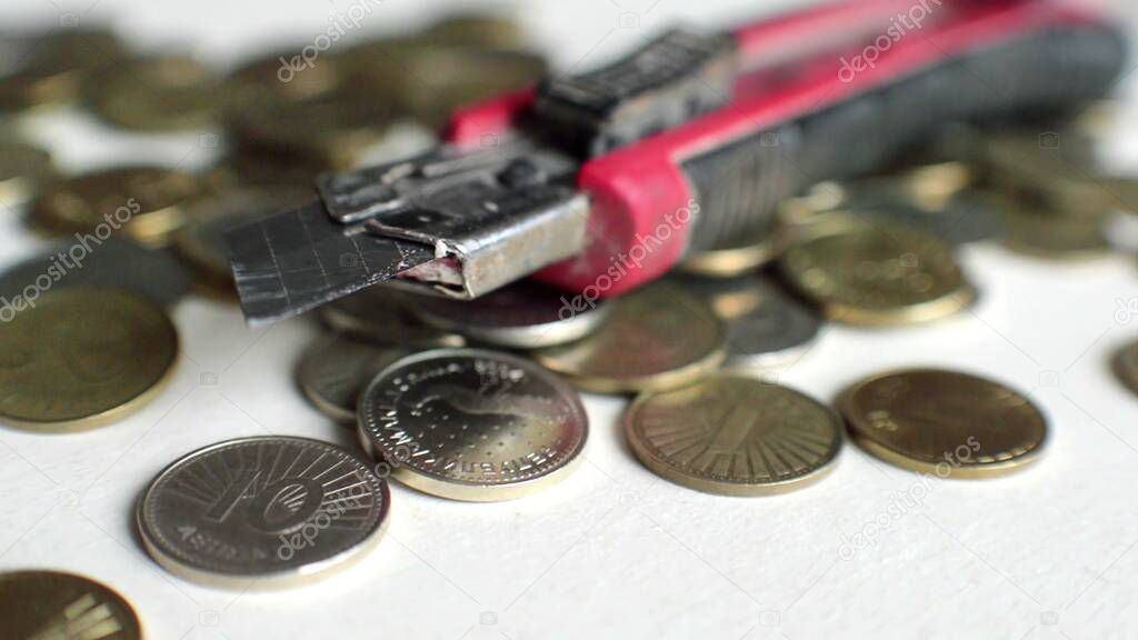 3D illustration - metal coins and cutter blade