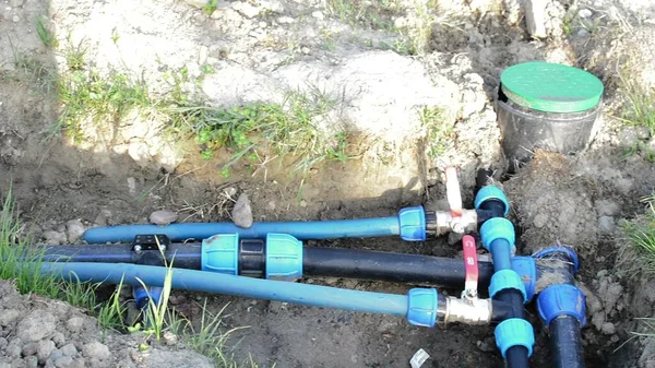 stock image 3d illustration - connected plastic water tubes in the ditch