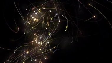 Siyah bir arkaplan üzerinde parlayan izler taşıyan dönen soyut ışık parçacıkları