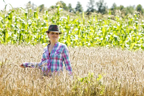 Young woman standing in a wheat field — Stock Photo, Image