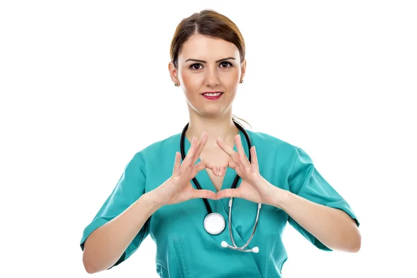 Young  female doctor with stethoscope making heart shape — Stock Photo, Image