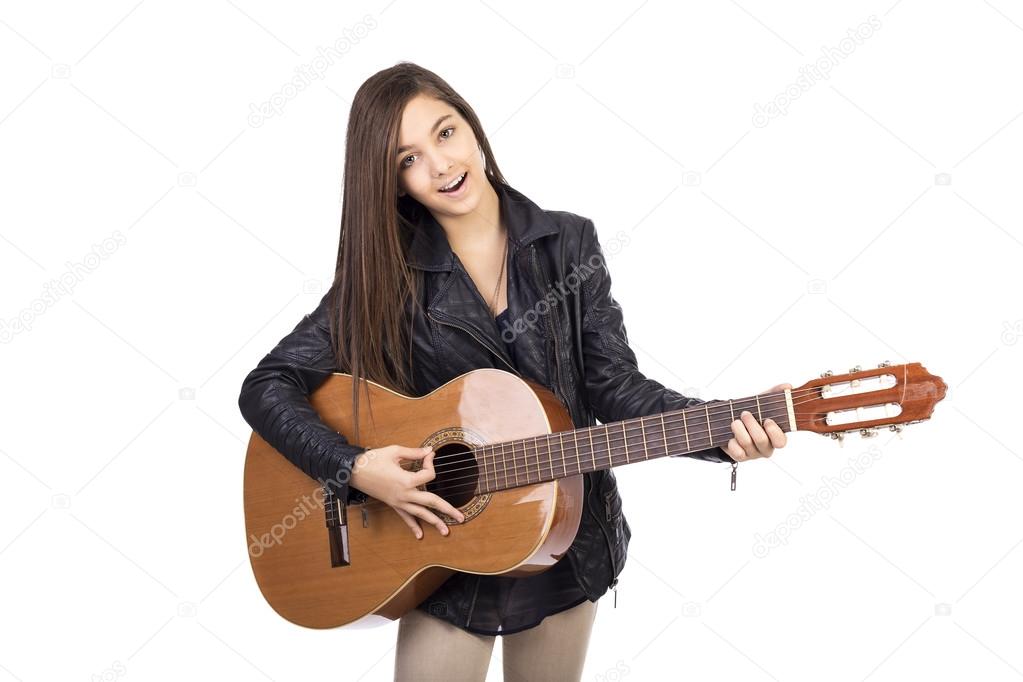 Beautiful teenager playing guitar and singing