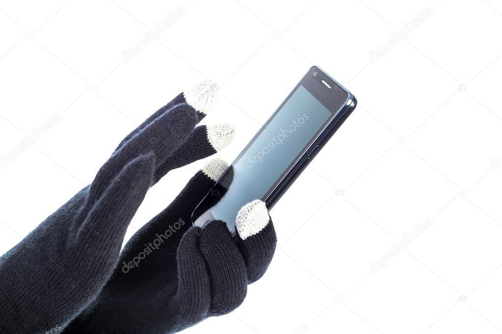 Closeup of woman hands with touchscreen gloves holding smart pho