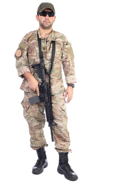 Full length portrait of young man in army clothes holding a weap — Stock Photo, Image