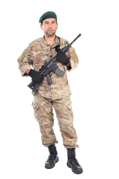 Full length portrait of young man in army clothes holding a weap — Stock Photo, Image