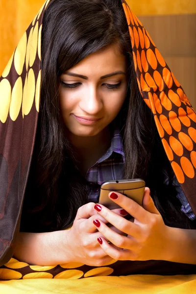 Closeup portrait of beautiful teenage girl using mobil phone hid — Stock Photo, Image