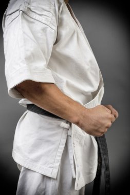 Genç adam beyaz kimono ve kara kuşak eğitimi savaş sanatı