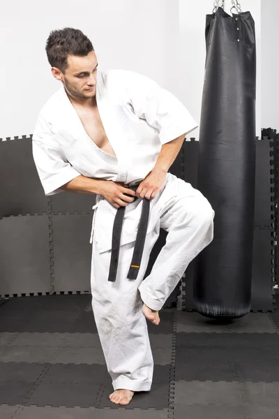 Ganztägiges Porträt eines jungen Mannes im Kimono-Karate lizenzfreie Stockbilder