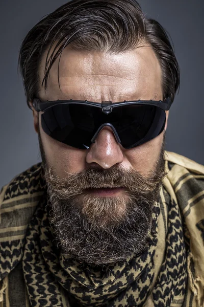 Closeup portrait of a young man with beard wearing a traditional — Stock Photo, Image