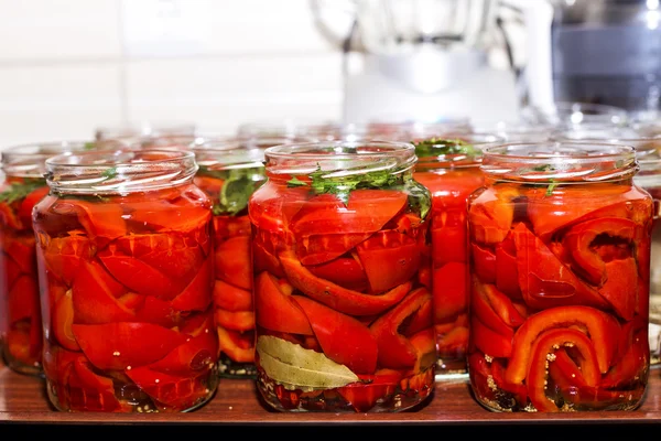 Pickled red sweet peppers in a glass jar — Stock Photo, Image