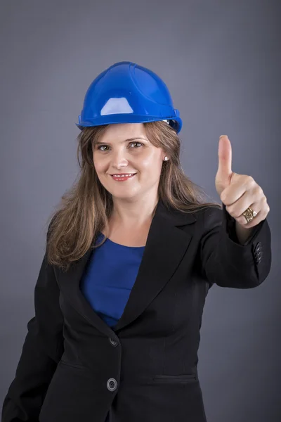 Happy young woman with hardhat showing ok sign — Stock Photo, Image