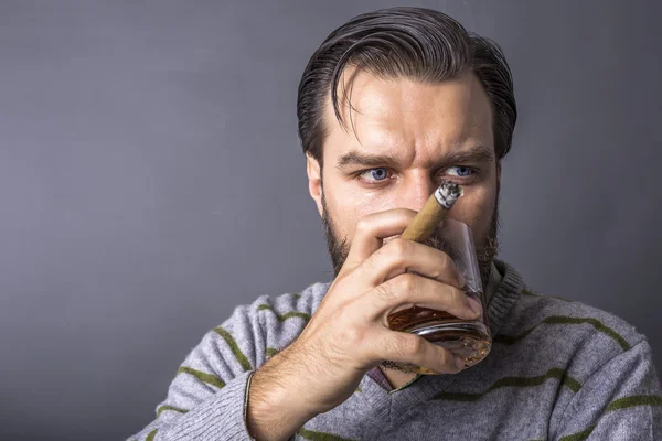 Studio shot of a handsome young man with retro look smoking a ci — Stock Photo, Image