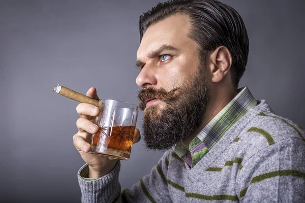 Studio shot of a handsome young man with retro look smoking a ci — Stock Photo, Image