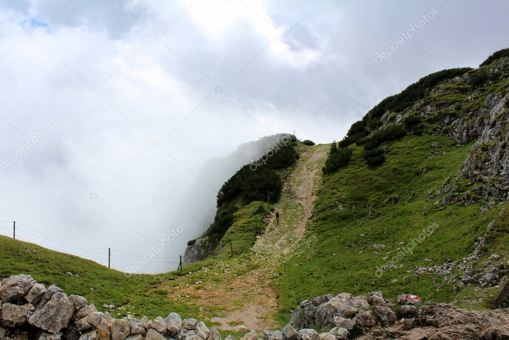 Beautiful view of the mountainous landscapes of the Alps shrouded in fog in summer. Salzburg mountains, Mountain Untersberg. Walk in the mountains