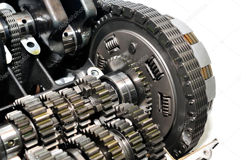 Motorcycle clutch with drive chain and gears in front.