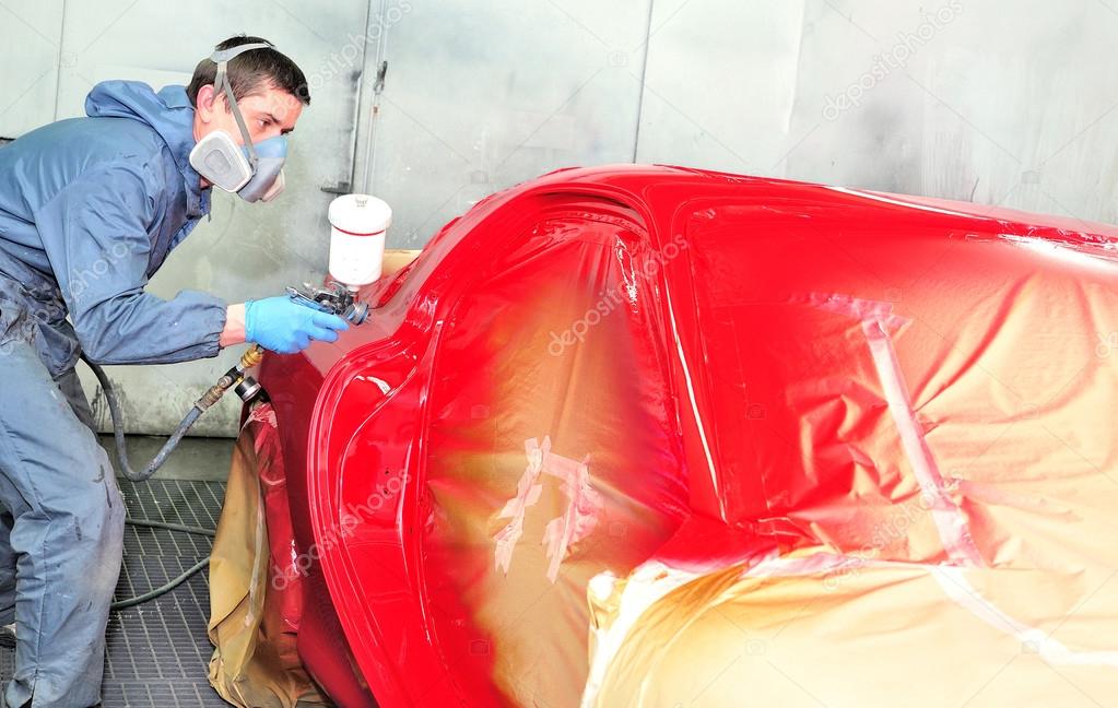 Worker painting red car. Stock Photo by ©lorakss 98515156