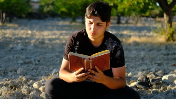 Homem lendo Alcorão ao ar livre — Vídeo de Stock