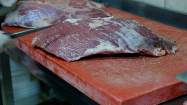 Режет сырое мясо ножом — стоковое видео