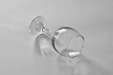 Empty glass goblet on the table. Black and white image.