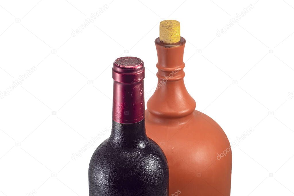 A bottle of red wine in dew drops from a cold basement on a white background.