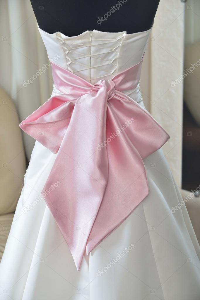 Wedding dress with pink bow and corset — Stock Photo
