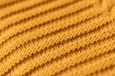 Hardal örülmüş battaniye elle örülmüş. Yünün arkaplan turuncu rengi.