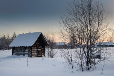 Cottage in the village one snowy morning in Russia clipart