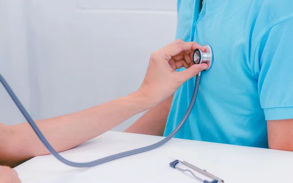 Senior Patient Having Medical Exam With Doctor In Office,Senior