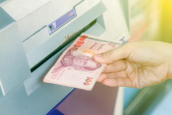 ATM machine withdrawing money,Close-up Of Person Withdrawing Mon