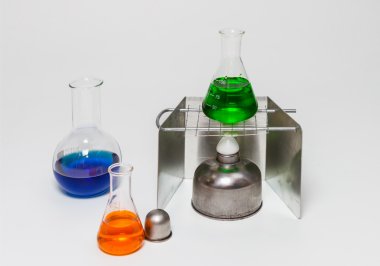 Group of laboratory flasks empty or filled with a clear liquid.